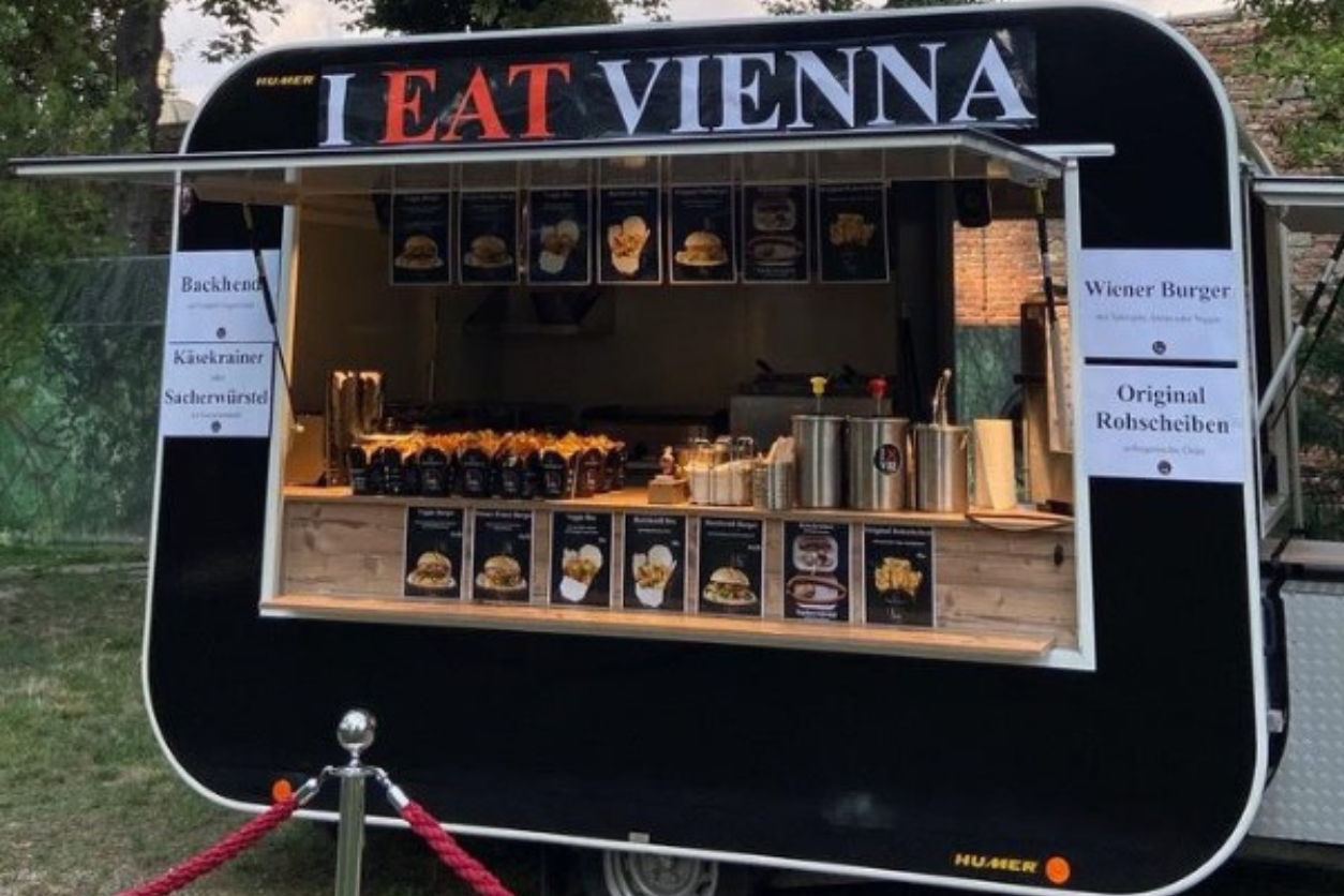 Foodtruck mit geöffneter Seitenwand und Aufschrift I eat Vienna