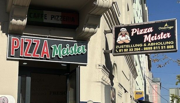 Hausecke des Pizza Meisters mit Schild